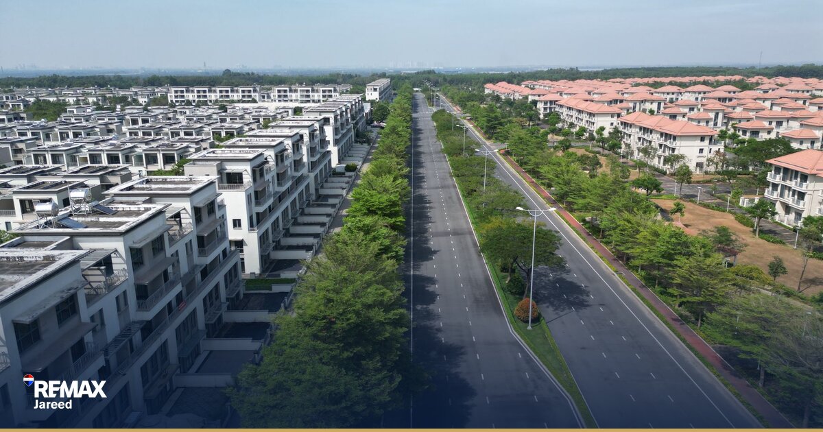Aerial view of luxury villa compound in Sheikh Zayed with landscaped streets and contemporary architecture