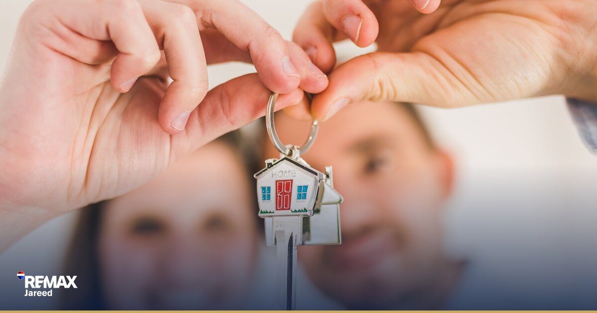 Home buyer reviewing financial documents and calculating down payment for property purchase