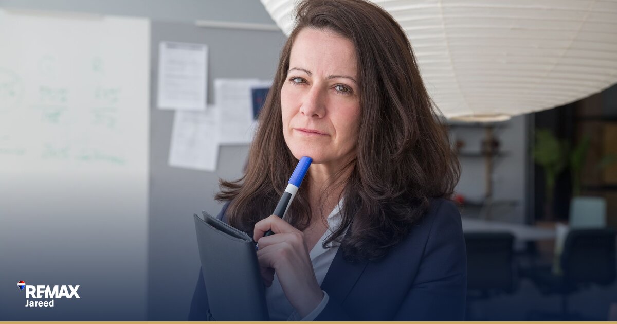 Property consultant reviewing commission statement and earnings report in modern West Cairo real estate office
